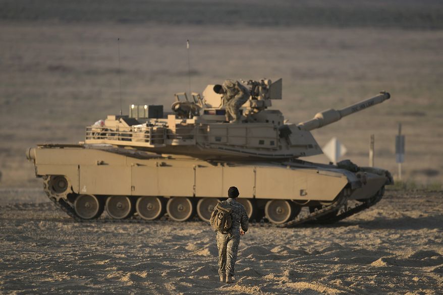 With morning light beginning to spread across the Orchard Combat Training Center’s newest Digital Air Ground Integrated Range (DAGIR), B Company tank crews begin heading toward their tanks to begin the first day of gunnery qualification. GOWEN FIELD, BOISE, IDAHO, UNITED STATES 05.17.2021. Photo by Thomas Alvarez / Idaho Army National Guard.