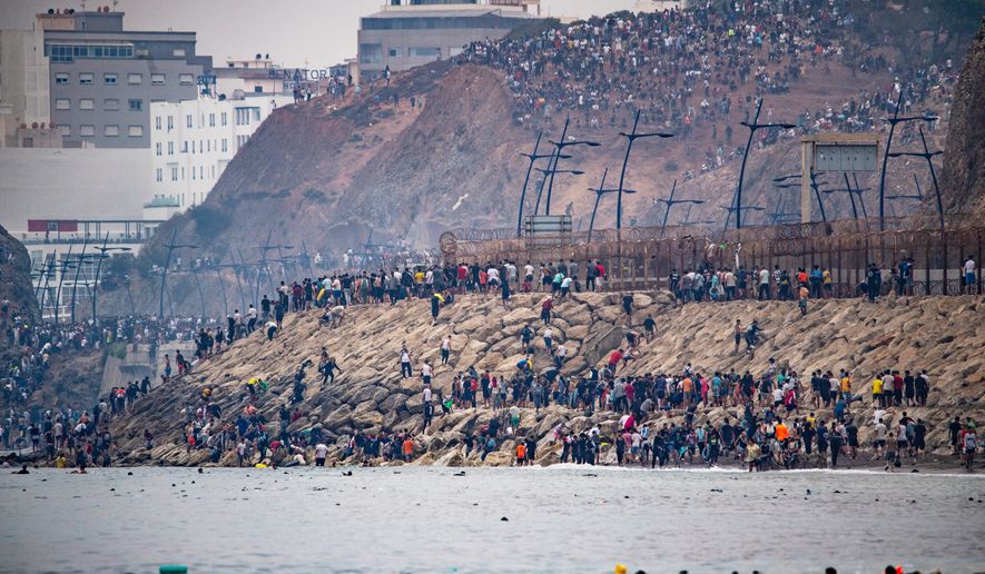 Migrants return to Morocco from the Spanish enclave of Ceuta, Friday, July 31, 2026. (AP Photo/Antonio Sempere)