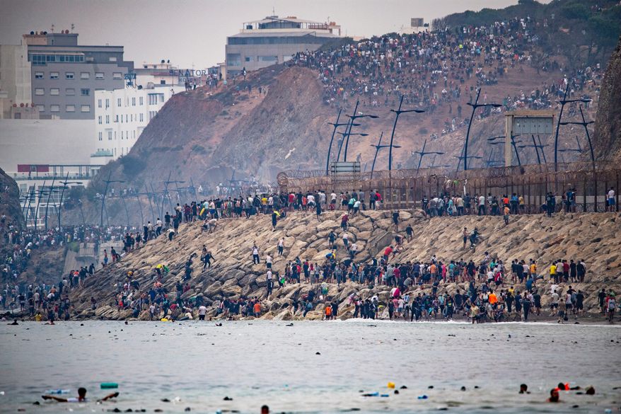 Migrants return to Morocco from the Spanish enclave of Ceuta, Friday, July 31, 2026. (AP Photo/Antonio Sempere)