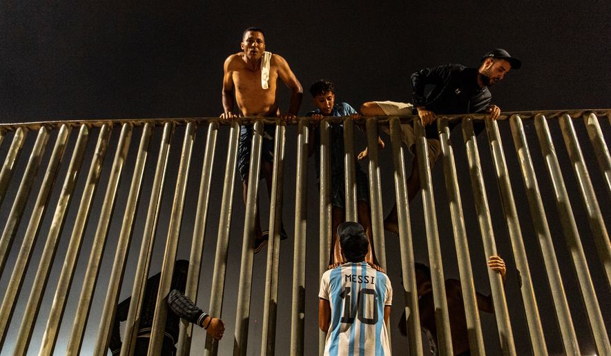 Migrants try to cross from Morocco into the Spanish enclave of Ceuta, Friday, July 31, 2026. (AP Photo/Antonio Sempere)