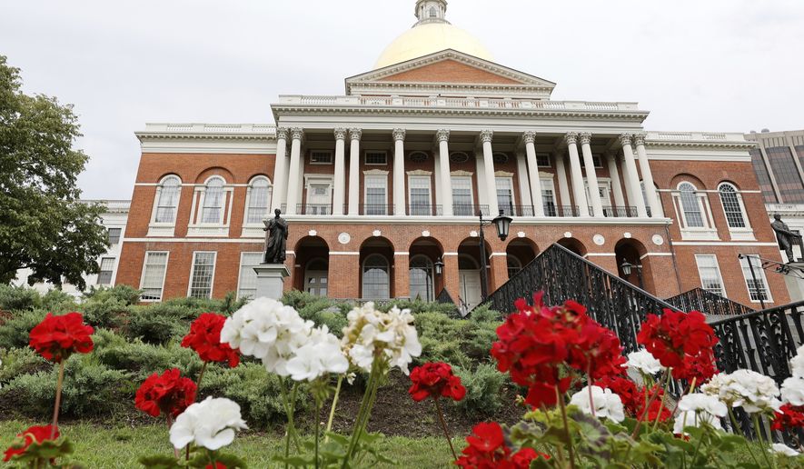 FILE - Flowers adorn the lawn in front of the Massachusetts State House, July 24, 2024, in Boston. (AP Photo/Mary Schwalm, File)