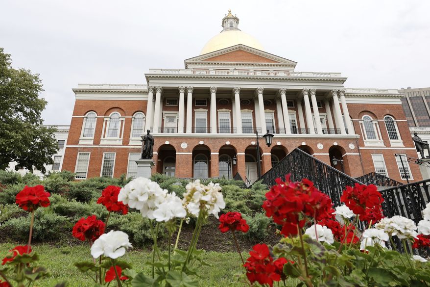 FILE - Flowers adorn the lawn in front of the Massachusetts State House, July 24, 2024, in Boston. (AP Photo/Mary Schwalm, File)