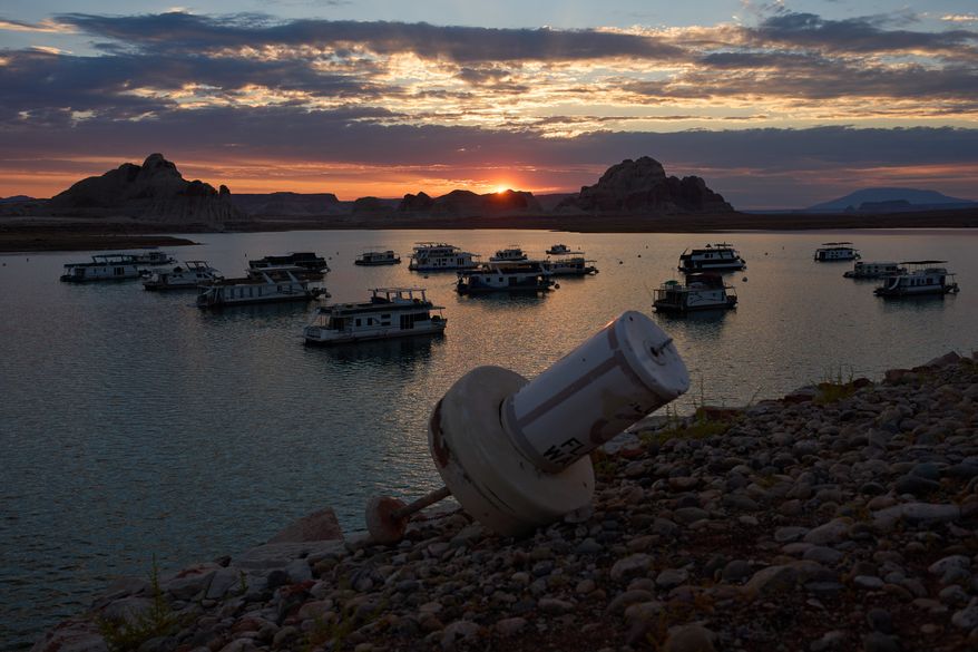FILE - A formerly floating buoy now sits high and dry above Lake Powell at the Glen Canyon National Recreation Area, July 15, 2026, near Page, Nev. (AP Photo/John Locher, File)