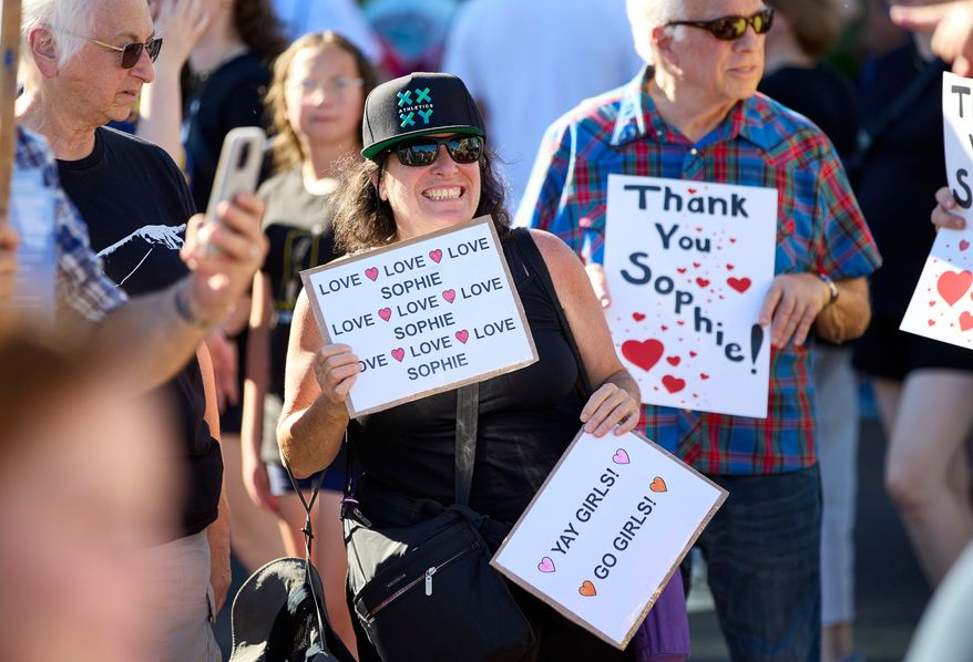 People rally to support Indiana Fever guard Sophie Cunningham after her comments on transgender athletes in women's sports before a WNBA basketball game between the Portland Fire and the Indiana Fever in Portland, Ore., Friday, July 31, 2026. (AP Photo/Craig Mitchelldyer)