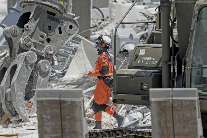 A firefighter searches the damaged AEON Mall following an explosion triggered by an earthquake in Kashima, Kumamoto Prefecture, southern Japan, Friday, July 31, 2026. (Kai Naito/Kyodo News via AP)