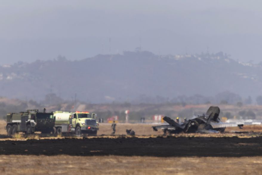 Crews work to douse a F-35 fighter jet that crashed near the run way at Marine Corps Air Station Miramar on Friday, July 31, 2026, in San Diego. (Luke Johnson/The San Diego Union-Tribune via AP)