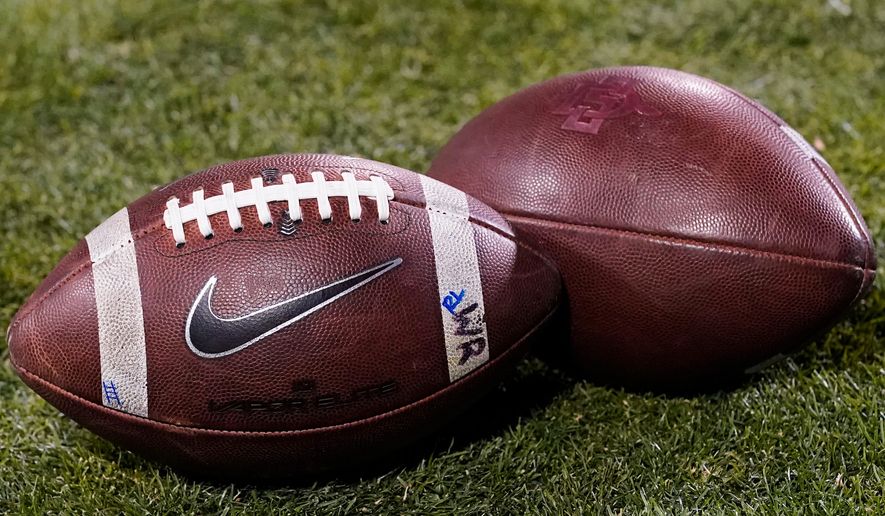 FILE - Footballs rest on the field in the second half of an NCAA college football game Nov. 28, 2020, in Boulder, Colo. (AP Photo/David Zalubowski, File)