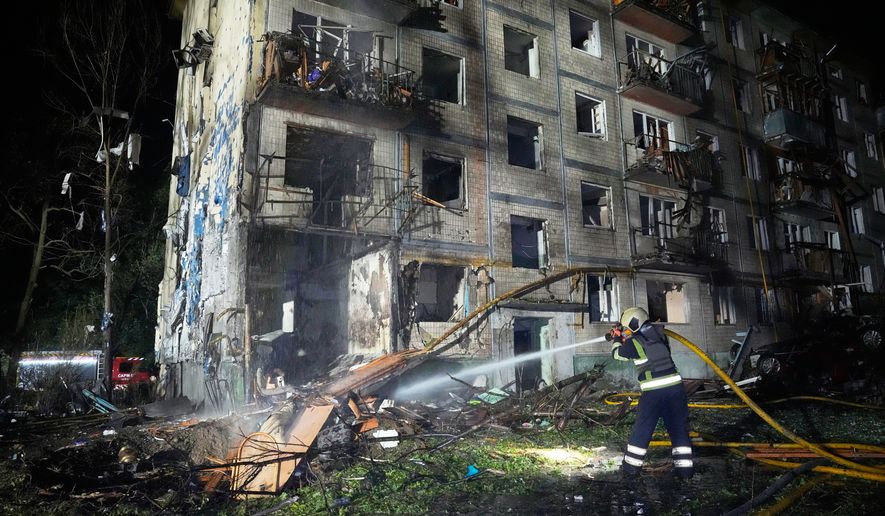 Emergency services personnel work to extinguish a fire following Russian missile attacks in Kyiv, Ukraine, Saturday, Aug. 1, 2026. (AP Photo/Efrem Lukatsky)