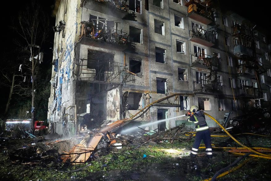 Emergency services personnel work to extinguish a fire following Russian missile attacks in Kyiv, Ukraine, Saturday, Aug. 1, 2026. (AP Photo/Efrem Lukatsky)