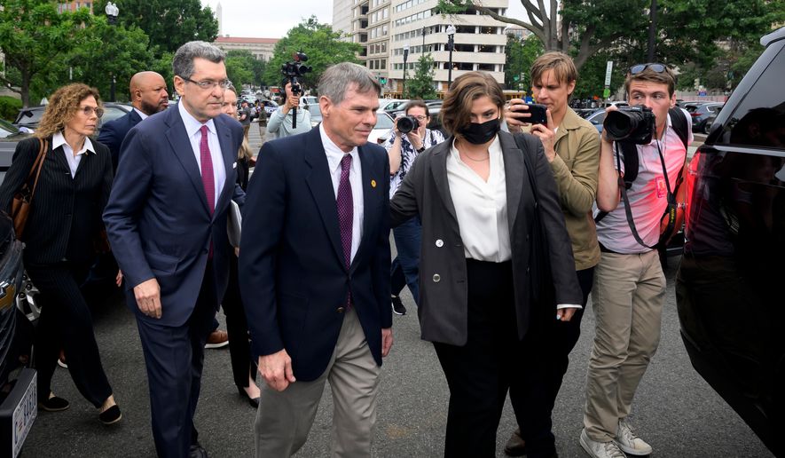 Former Olympic canoeist David Hearn, center, and his attorney Norman Eisen, left, walk to a car following a court appearance, where he pleaded not guilty to allegedly damaging the Lincoln Memorial Reflecting Pool, Thursday, July 9, 2026, in Washington. (AP Photo/Rod Lamkey, Jr.)