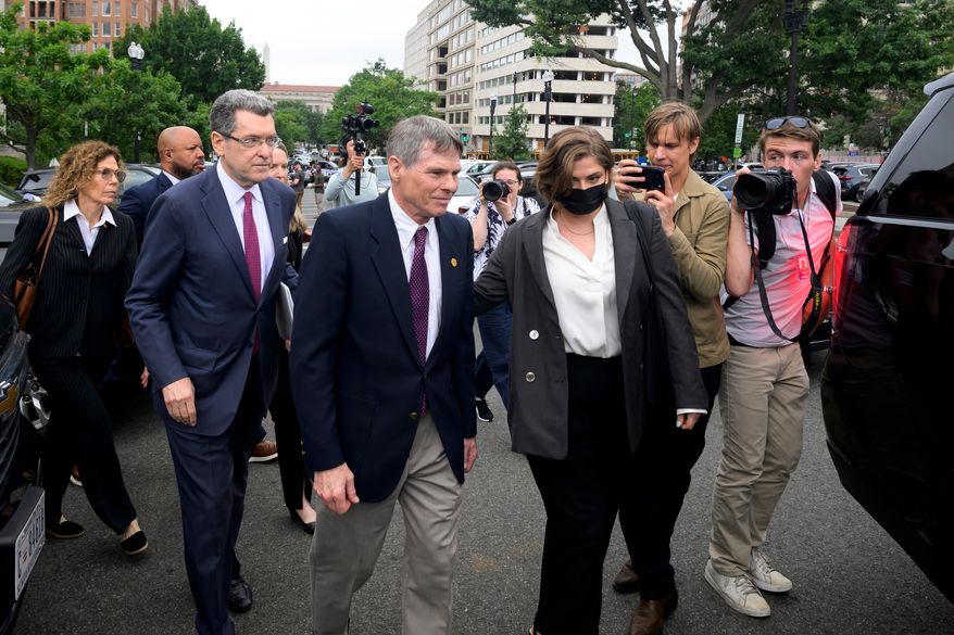 Former Olympic canoeist David Hearn, center, and his attorney Norman Eisen, left, walk to a car following a court appearance, where he pleaded not guilty to allegedly damaging the Lincoln Memorial Reflecting Pool, Thursday, July 9, 2026, in Washington. (AP Photo/Rod Lamkey, Jr.)