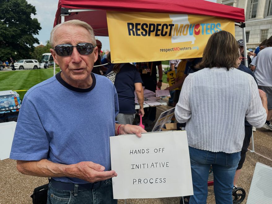 FILE - John Billman, of Columbia, Mo., holds a sign explaining his opposition to a state legislative proposal that would make it harder for voters to approve citizen-initiated constitutional amendments while rallying at the state Capitol in Jefferson City, on Wednesday, Sept. 10, 2025. (AP Photo/David A. Lieb, File)