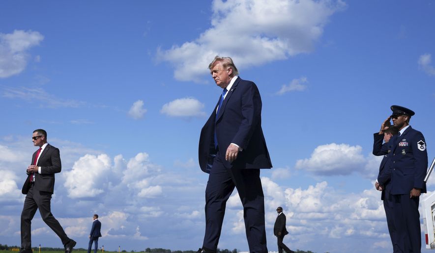 President Donald Trump, center, walks from Air Force One at Morristown Municipal Airport in Morristown, N.J., Friday, July 31, 2026, from Camp David, the presidential retreat. (AP Photo/Jacquelyn Martin)