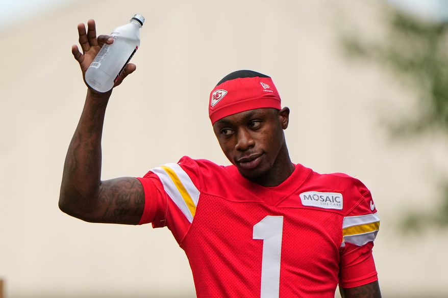 Kansas City Chiefs wide receiver Xavier Worthy waves to fans as he arrives at NFL football training camp Friday, July 31, 2026, in St. Joseph, Mo. (AP Photo/Charlie Riedel)