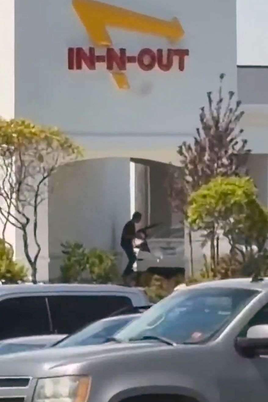 This still image captured from video by a witness shows the scene of a shooting that started at an In-N-Out Burger restaurant, Saturday, Aug. 1, 2026 in Twin Falls, Idaho. (Kevin Bell Jr. via AP)