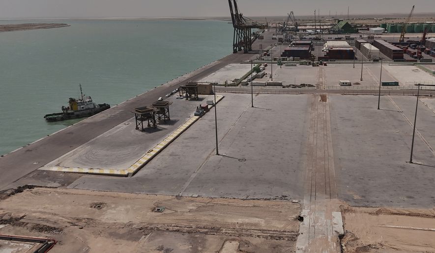 This aerial photo shows the port of Umm Qasr empty of commercial ships and cargo ships, near the city of Basra, 340 miles (550 kilometers) southeast of Baghdad, Iraq, Tuesday, July 28, 2026. (AP Photo/Ali Rahim)