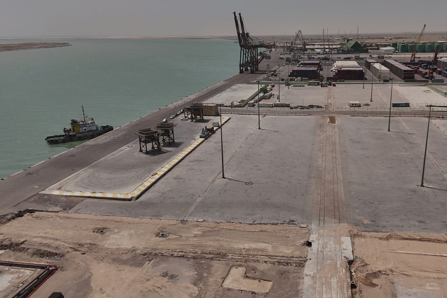 This aerial photo shows the port of Umm Qasr empty of commercial ships and cargo ships, near the city of Basra, 340 miles (550 kilometers) southeast of Baghdad, Iraq, Tuesday, July 28, 2026. (AP Photo/Ali Rahim)