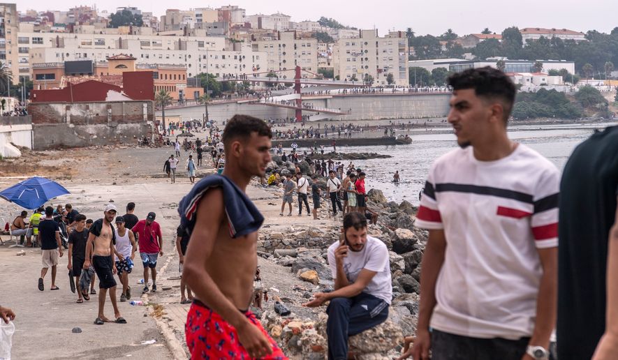 Migrants return to Morocco from the Spanish enclave of Ceuta, Friday, July 31, 2026. (AP Photo/Antonio Sempere)