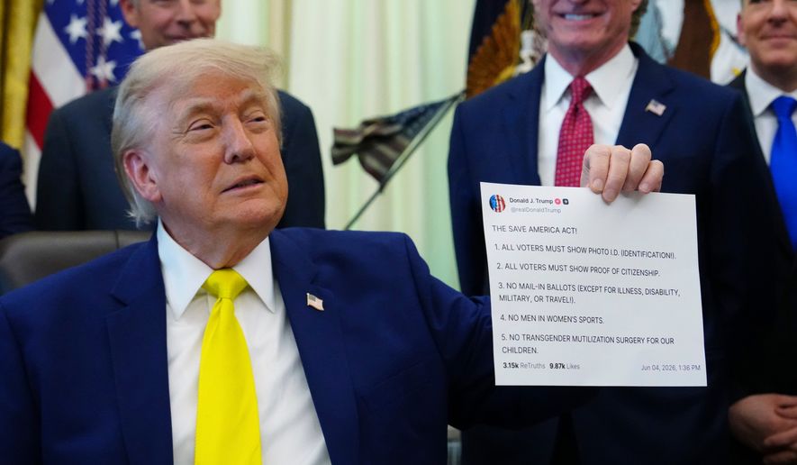 President Donald Trump holds up an image taken from his Truth Social account at an event about coal, Thursday, June 4, 2026, in the Oval Office of the White House in Washington. (AP Photo/Julia Demaree Nikhinson,File)