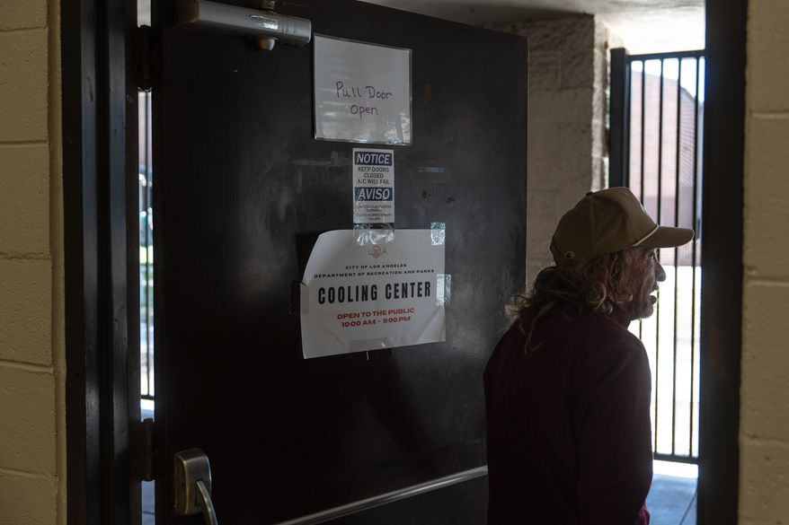Daniel Aragonez leaves a cooling center in Los Angeles, Friday, July 31, 2026. (AP Photo/Jae C. Hong)