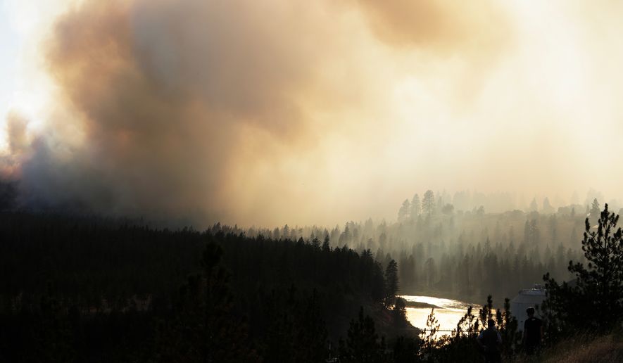 Old Trails Fire is seen from W. Northwest Blvd., Saturday, Aug. 1, 2026, in Spokane, Wash. (AP Photo/Young Kwak)
