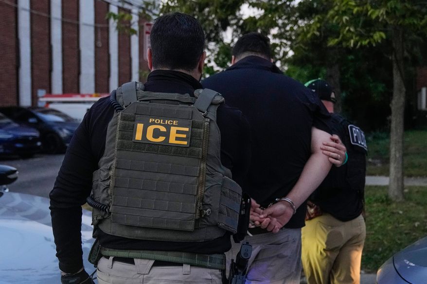 U.S. Immigration and Customs Enforcement agents make an arrest during an early morning operation in Park Ridge, Ill., Sept. 19, 2025. (AP Photo/Erin Hooley, File)