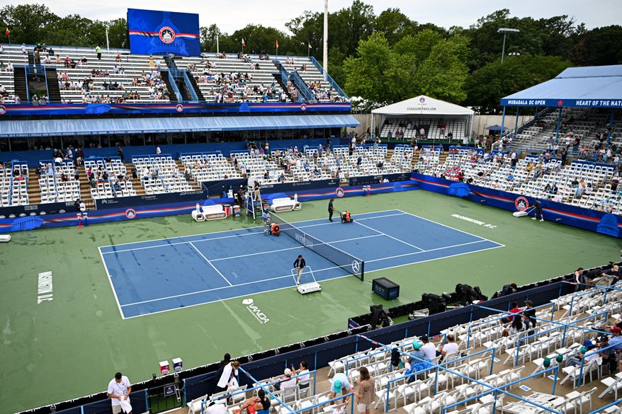 Workers dry off the Stadium court during the WTA final of the DC Open tennis tournament in Washington, D.C., Sunday, August 2, 2026. Play was delayed twice due to lengthy thunderstorms in the area. (All-Pro Reels)