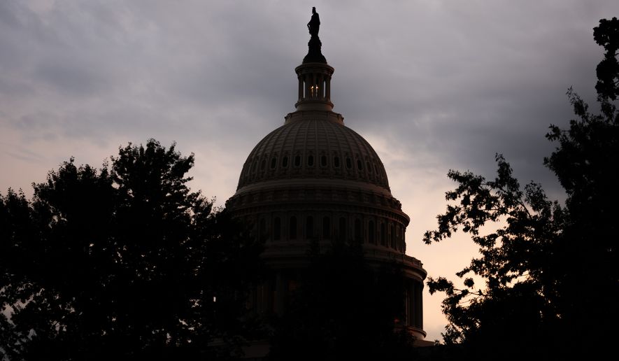 The sun sets behind the U.S. Capitol, Tuesday, July 28, 2026, in Washington. (AP Photo/Allison Robbert)