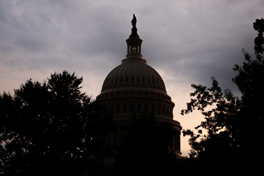 The sun sets behind the U.S. Capitol, Tuesday, July 28, 2026, in Washington. (AP Photo/Allison Robbert)