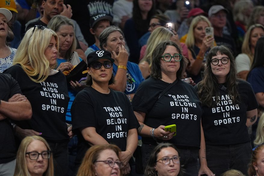 Fans wear shirts saying "Trans Kids Belong In Sports" during a WNBA basketball game between the Minnesota Lynx and the Indiana Fever Sunday, Aug. 2, 2026, in Minneapolis. (AP Photo/Abbie Parr)