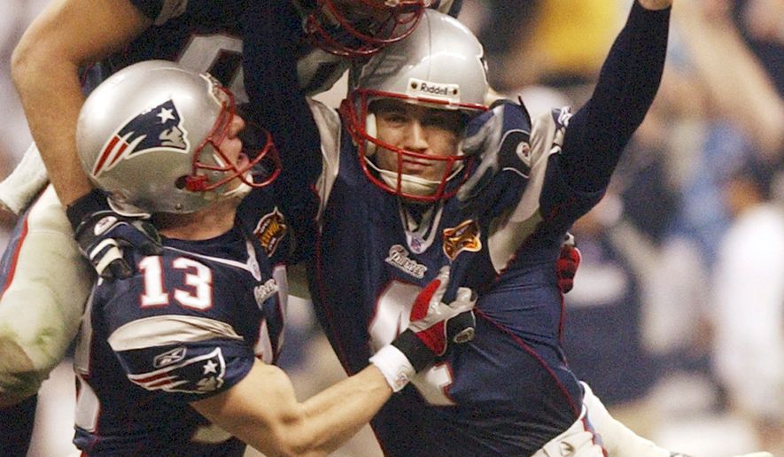 FILE - New England Patriots kicker Adam Vinatieri celebrates his game-winning field goal with teammates Ken Walter (13) and Christian Fauria (88) in the final seconds of Super Bowl XXXVIII against the Carolina Panthers at Reliant Stadium in Houston, Feb. 1, 2004. (AP Photo/Dave Martin, File)