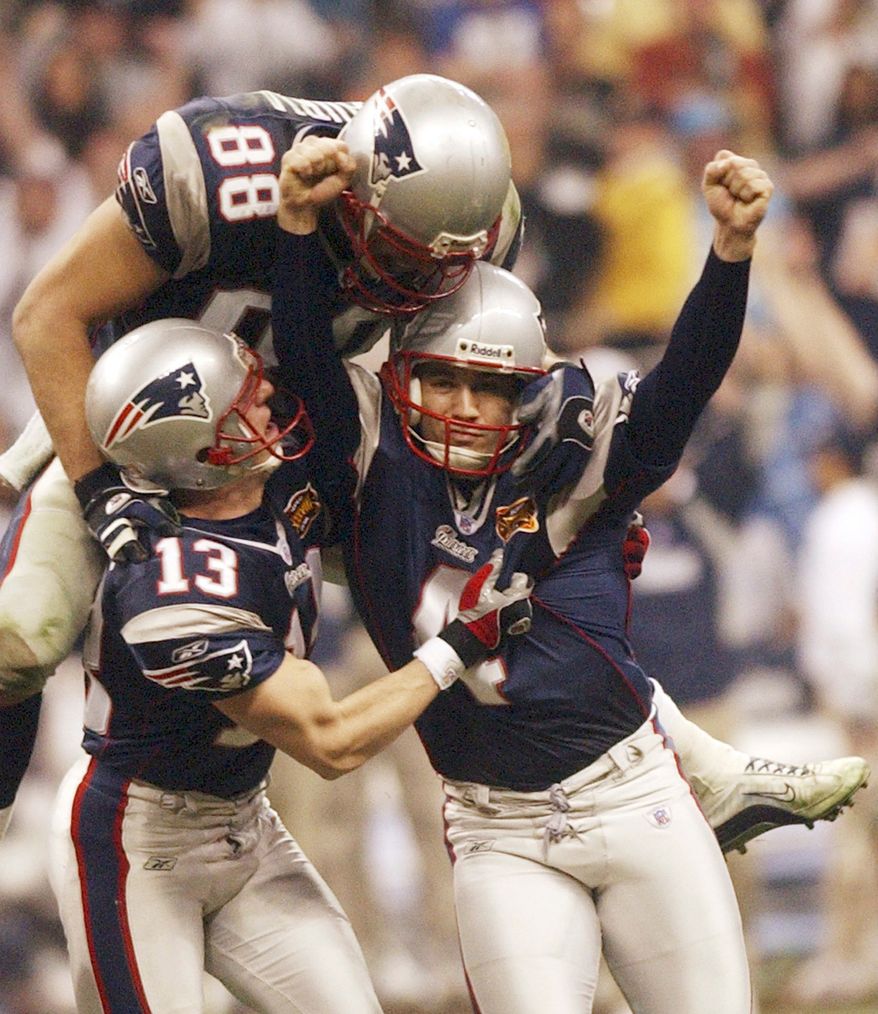 FILE - New England Patriots kicker Adam Vinatieri celebrates his game-winning field goal with teammates Ken Walter (13) and Christian Fauria (88) in the final seconds of Super Bowl XXXVIII against the Carolina Panthers at Reliant Stadium in Houston, Feb. 1, 2004. (AP Photo/Dave Martin, File)