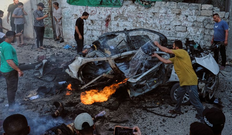 Palestinians try to extinguish a burning car after an Israeli military strike in Gaza City, Sunday, Aug. 2, 2026. (AP Photo/Jehad Alshrafi)