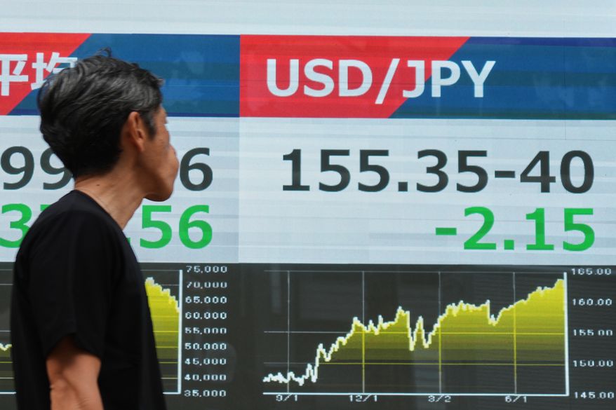 A person walks past an electronic board showing the U.S. dollar and Japanese yen exchange rate at a securities firm in Tokyo on Monday, Aug. 3, 2026. (AP Photo/Eugene Hoshiko)