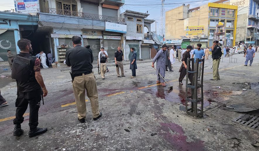 Police officers examine the site following a suicide bombing, in Kabal, a town in the Swat Valley in Pakistan's Khyber Pakhtunkhwa province, Sunday, Aug. 2, 2026. (AP Photo/Sherin Zada)