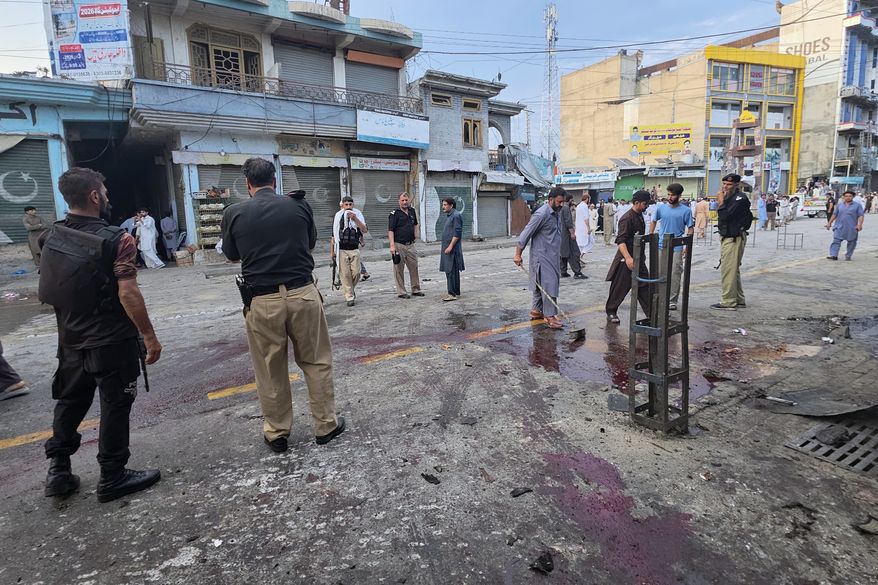 Police officers examine the site following a suicide bombing, in Kabal, a town in the Swat Valley in Pakistan's Khyber Pakhtunkhwa province, Sunday, Aug. 2, 2026. (AP Photo/Sherin Zada)
