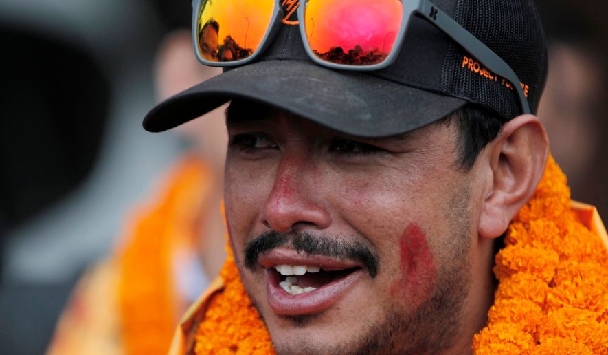 FILE - Nepalese mountaineer Nirmal Purja, who became the fastest climber of the world's 14 highest peaks, arrives at the airport in Kathmandu, Nepal, on Oct. 30, 2019. (AP Photo/Niranjan Shrestha, File)