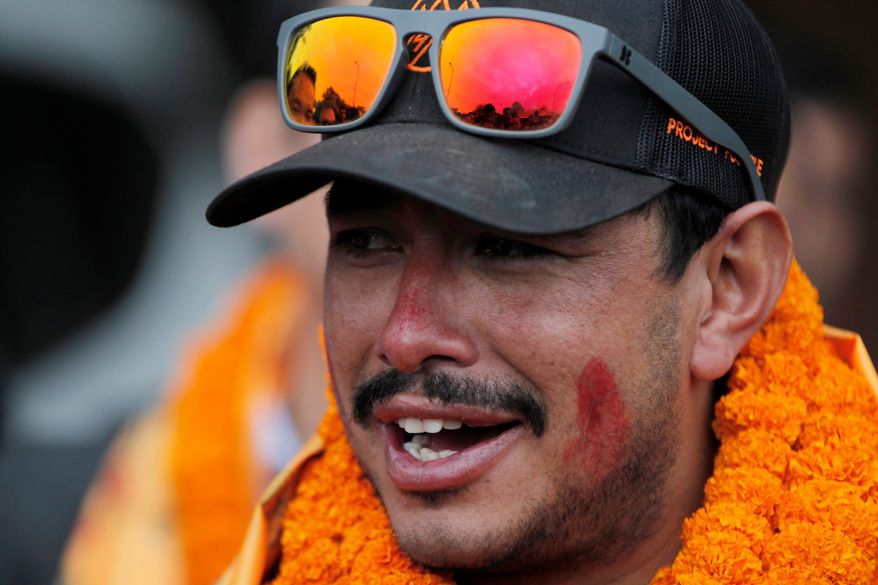 FILE - Nepalese mountaineer Nirmal Purja, who became the fastest climber of the world's 14 highest peaks, arrives at the airport in Kathmandu, Nepal, on Oct. 30, 2019. (AP Photo/Niranjan Shrestha, File)