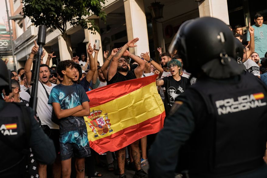 Ceuta residents demonstrate against the arrival of Spanish far-right politician Alvise Pérez in the Spanish enclave of Ceuta, Saturday, Aug. 1, 2026. (AP Photo/Bernat Armangue)
