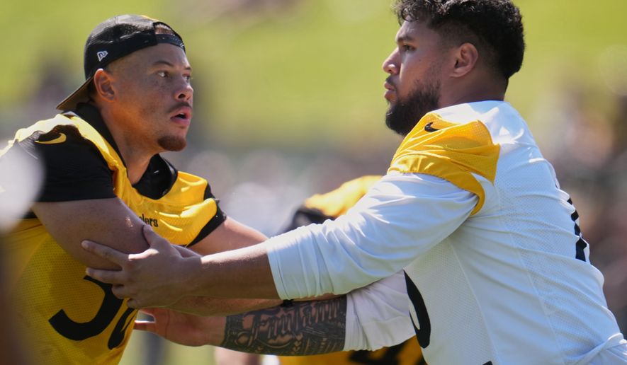 Pittsburgh Steelers linebacker Alex Highsmith (56), left, is blocked by offensive tackle Troy Fautanu during the team's NFL football training camp in Latrobe, Pa., on Friday, July 31, 2026.(AP Photo/Gene J. Puskar)