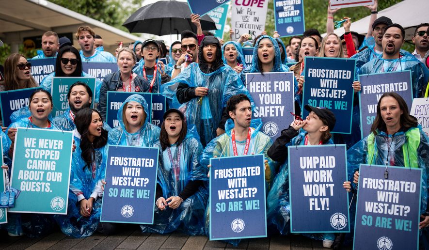 WestJet flight attendants strike at Vancouver International Airport in Richmond, British Columbia, Sunday, Aug. 2, 2026. (Ethan Cairns/The Canadian Press via AP)
