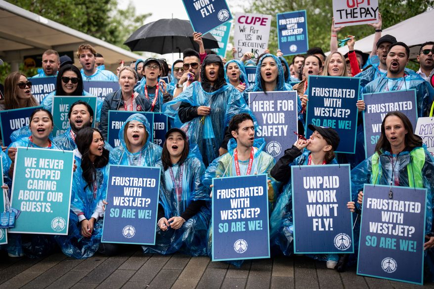 WestJet flight attendants strike at Vancouver International Airport in Richmond, British Columbia, Sunday, Aug. 2, 2026. (Ethan Cairns/The Canadian Press via AP)
