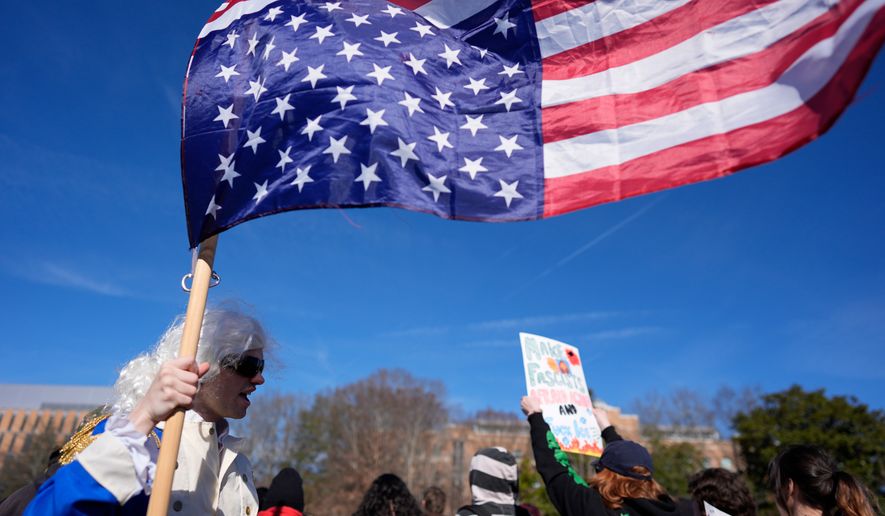 A student participates during an immigration protest on the campus of Kennesaw State University in Kennesaw, Ga., on Tuesday, Jan. 20, 2026. (AP Photo/Mike Stewart) **FILE**