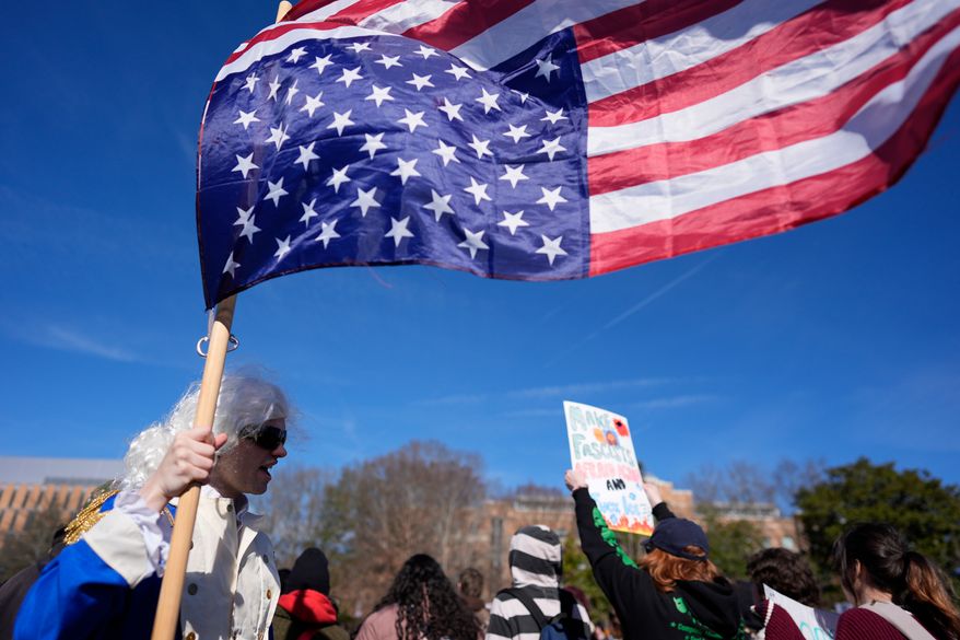 A student participates during an immigration protest on the campus of Kennesaw State University in Kennesaw, Ga., on Tuesday, Jan. 20, 2026. (AP Photo/Mike Stewart) **FILE**
