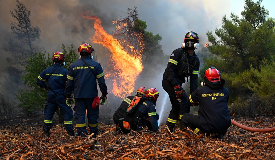 Firefighters operate during a wildfire near Porto Germeno, northwest of Athens, Greece, Sunday, Aug. 2, 2026. (AP Photo/Michael Varaklas)