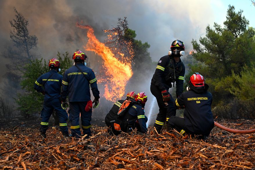 Firefighters operate during a wildfire near Porto Germeno, northwest of Athens, Greece, Sunday, Aug. 2, 2026. (AP Photo/Michael Varaklas)