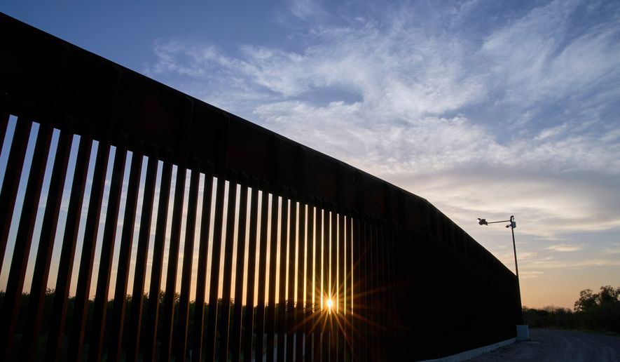 The sun sets over a section of the border wall, June 18, 2025, in Mission, Texas. (AP Photo/Jacquelyn Martin, File)
