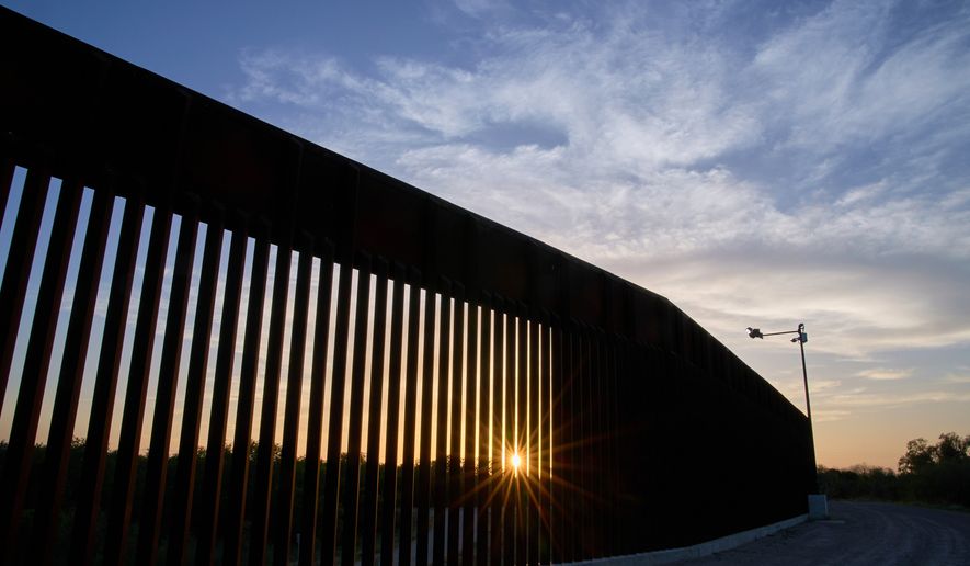 The sun sets over a section of the border wall, June 18, 2025, in Mission, Texas. (AP Photo/Jacquelyn Martin, File)