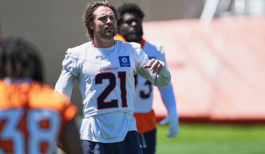 FILE - Denver Broncos cornerback Riley Moss (21) warms up during an NFL football practice June 17, 2026, at the team's headquarters in Centennial, Colo. (AP Photo/David Zalubowski, File)