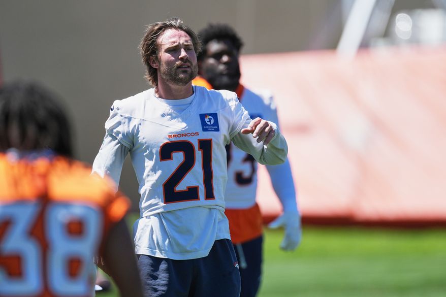 FILE - Denver Broncos cornerback Riley Moss (21) warms up during an NFL football practice June 17, 2026, at the team's headquarters in Centennial, Colo. (AP Photo/David Zalubowski, File)